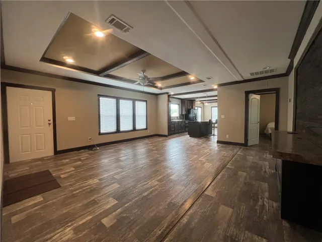 a view of a livingroom with furniture wooden floor and windows