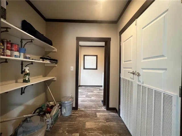 a hallway with front door wooden floor and windows