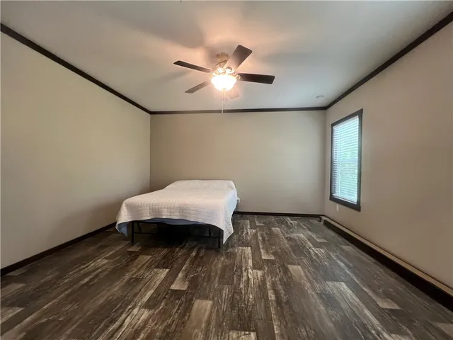 a spacious bedroom with a bed and a window