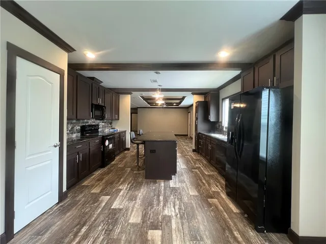 a kitchen with refrigerator and window