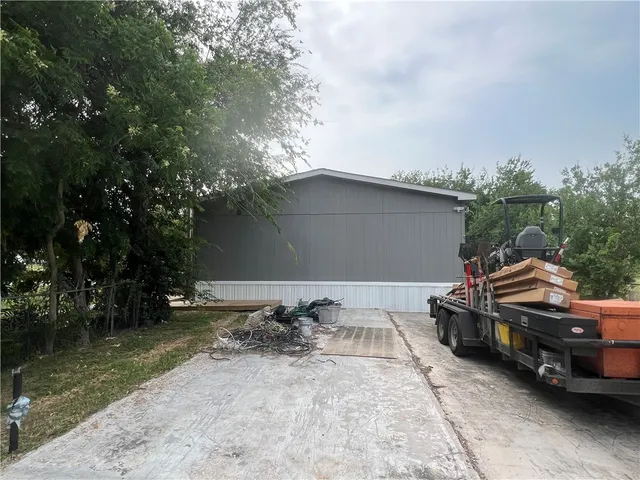 a backyard of a house with yard fire pit and outdoor seating