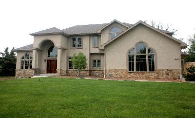 a front view of a house with a garden and yard