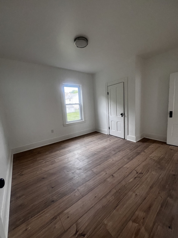 19 Reeves Street Worcester, MA 01607 - Photo 24 of 30 an empty room with wooden floor and windows