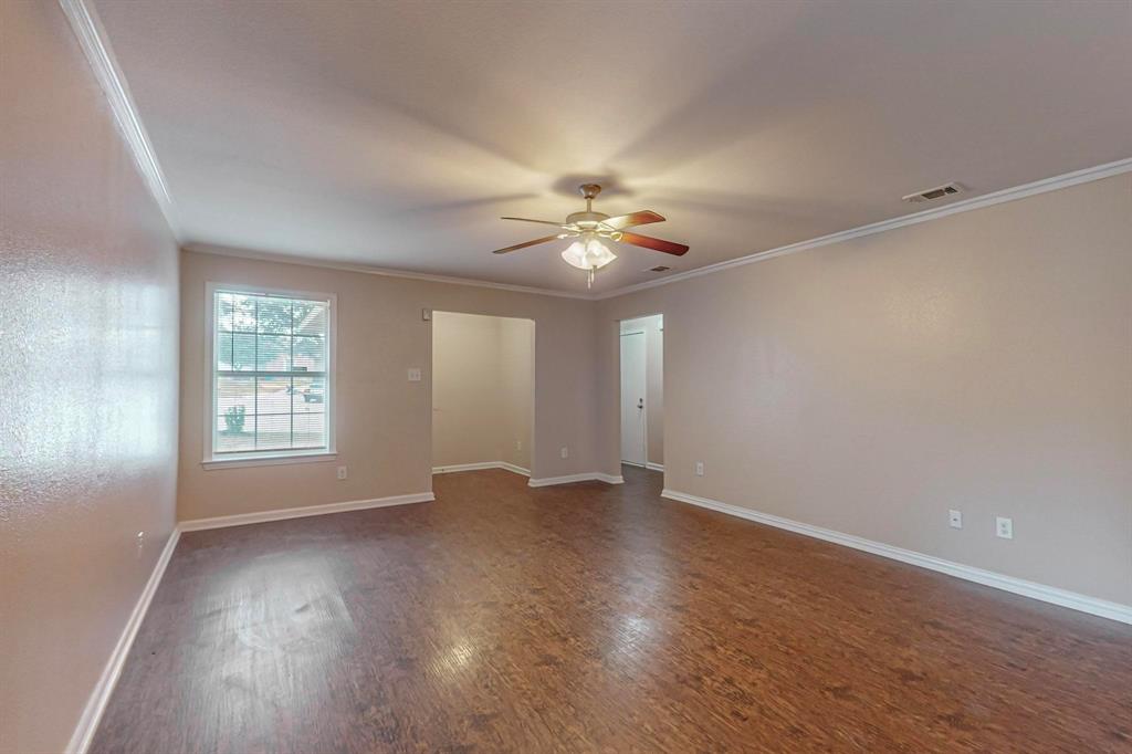 4827 Mexico Dallas, TX 75236 - Photo 3 of 31 a view of an empty room with a window and wooden floor