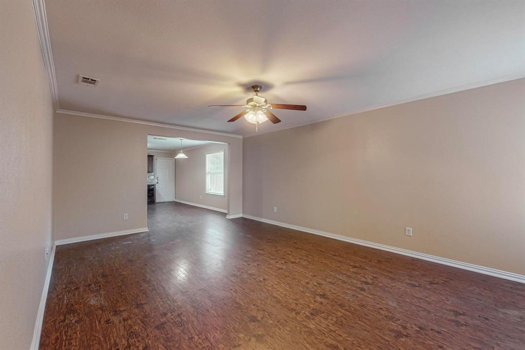 4827 Mexico Dallas, TX 75236 - Photo 4 of 31 a view of a room with wooden floor and a ceiling fan