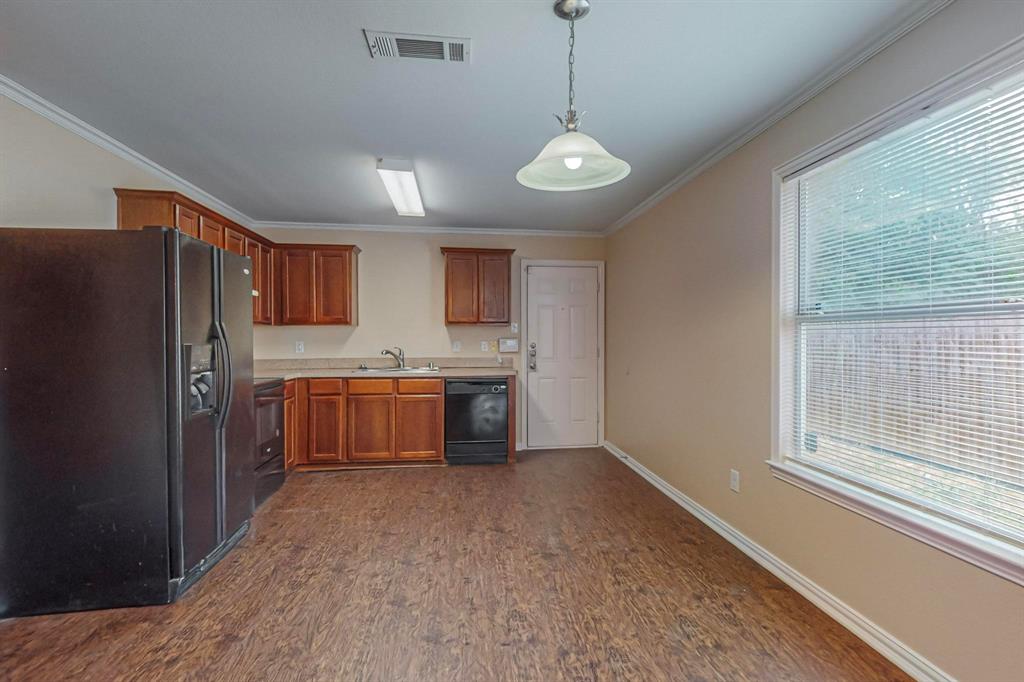 4827 Mexico Dallas, TX 75236 - Photo 7 of 31 a kitchen with stainless steel appliances a refrigerator sink and cabinets
