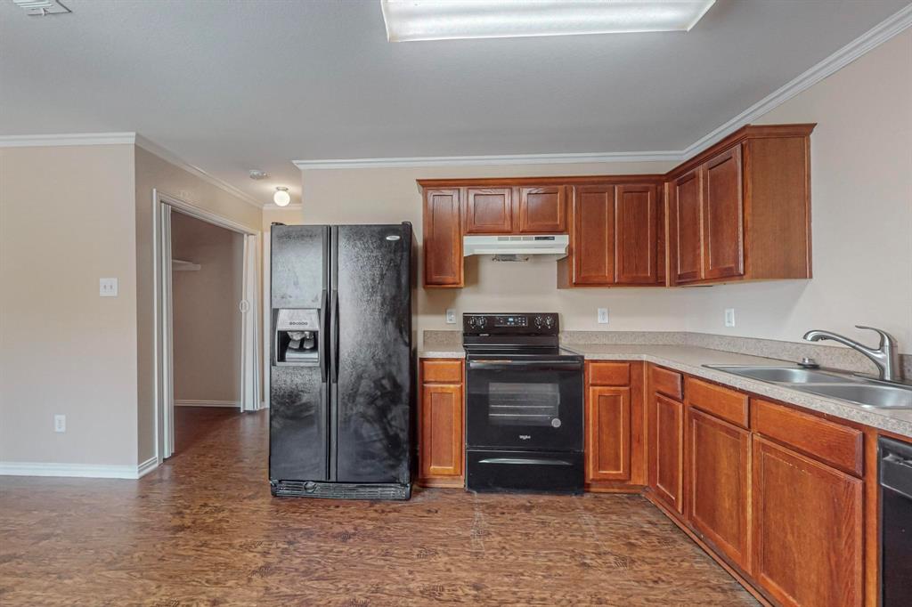 4827 Mexico Dallas, TX 75236 - Photo 9 of 31 a kitchen with stainless steel appliances granite countertop a refrigerator and a sink