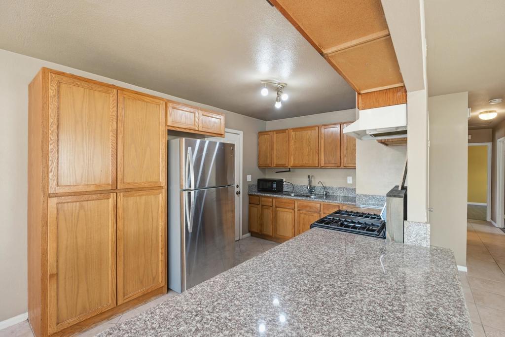 4062 Lewis Street Oceanside, CA 92056 - Photo 6 of 23 a kitchen with stainless steel appliances granite countertop a refrigerator and a stove