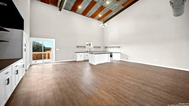 a view of a kitchen with wooden floors and kitchen