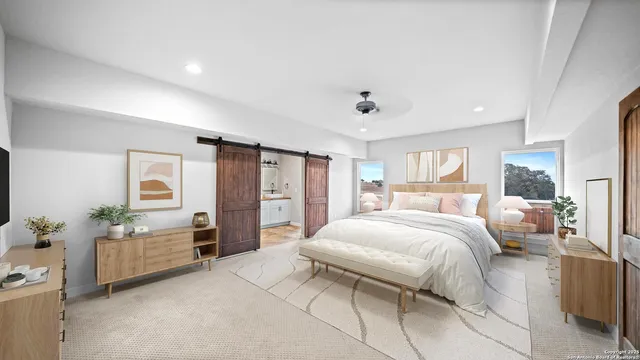 a bedroom with a large bed and furniture