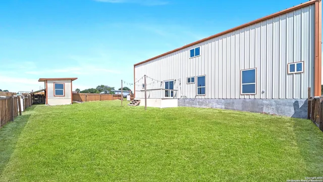 a view of backyard with a garden and deck