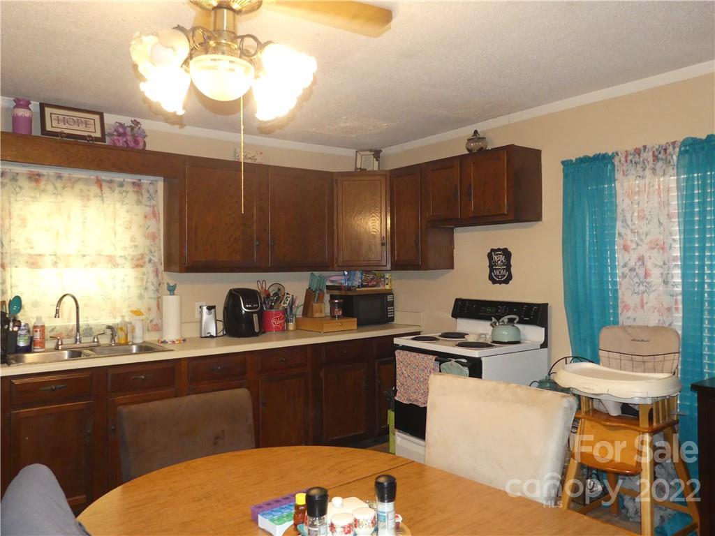 761 Mackey Freeman Road Bostic, NC 28018 - Photo 3 of 11 a kitchen with a sink a stove and cabinets