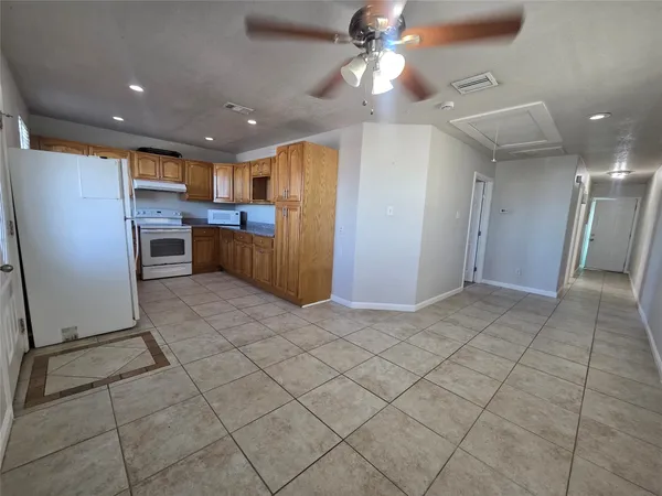 a view of a kitchen with a sink and a refrigerator