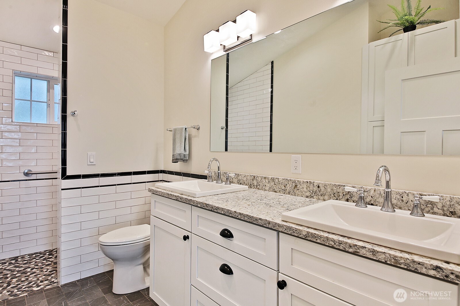 2999 Saratoga Road Langley, WA 98260 - Photo 20 of 40 a bathroom with a granite countertop sink a toilet and a mirror