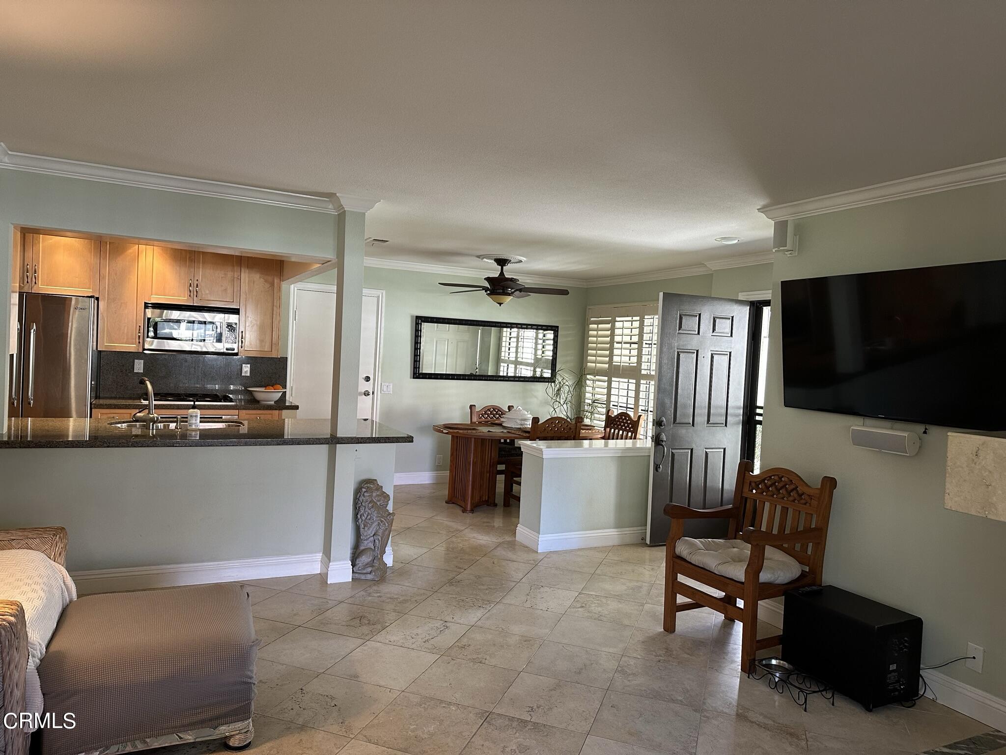 4475 Antigua Way Oxnard, CA 93035 - Photo 6 of 31 a living room with furniture a flat screen tv and kitchen view