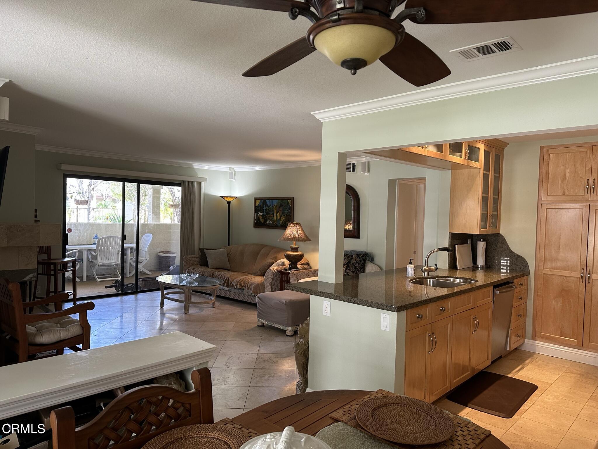 4475 Antigua Way Oxnard, CA 93035 - Photo 8 of 31 a living room with furniture kitchen view and a large window