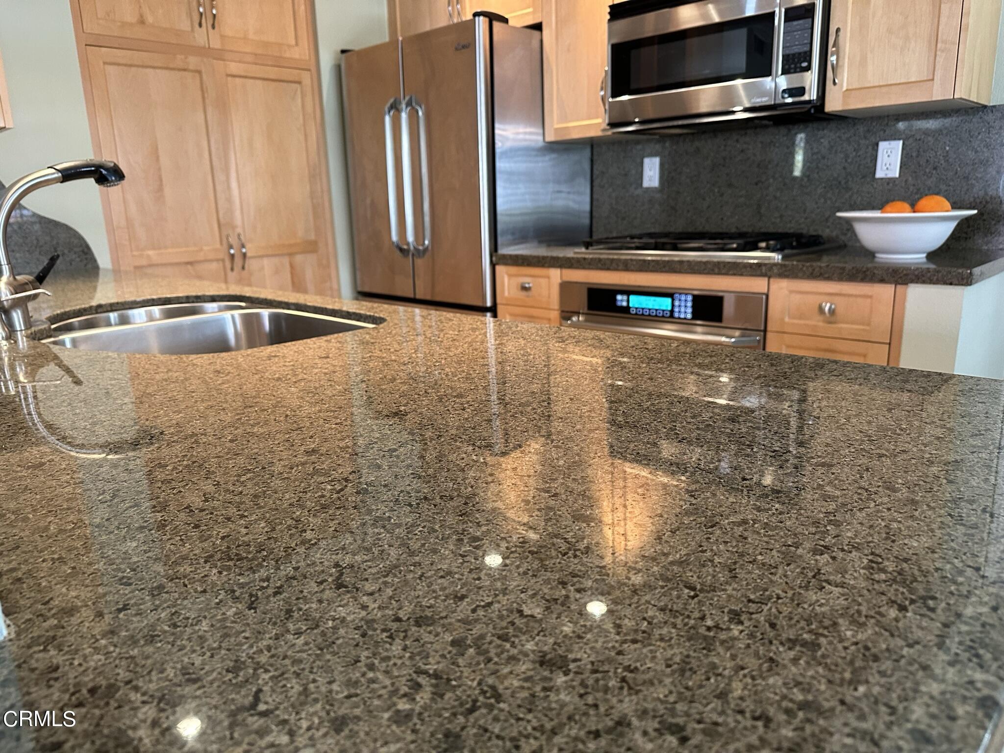 4475 Antigua Way Oxnard, CA 93035 - Photo 9 of 31 a kitchen with stainless steel appliances granite countertop a sink a stove and a microwave