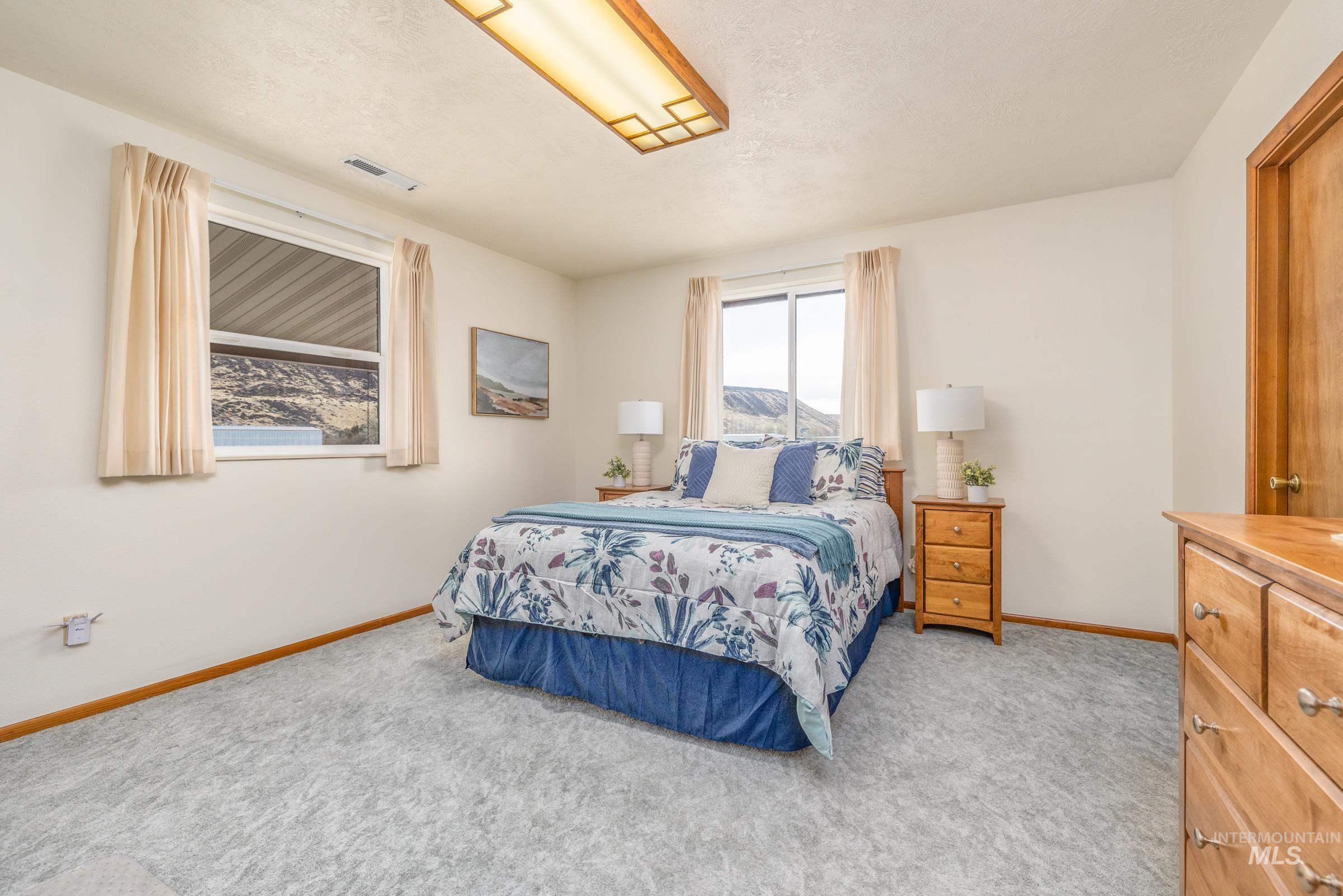 10514 Airpark Loop Road Melba, ID 83641 - Photo 23 of 48 Bedroom featuring baseboards and light colored carpet