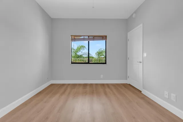 a view of room with window and wooden floor