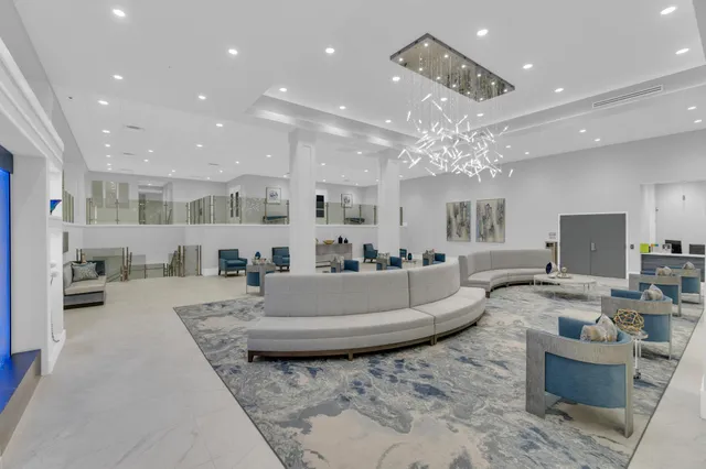 a living room with fireplace furniture and a chandelier