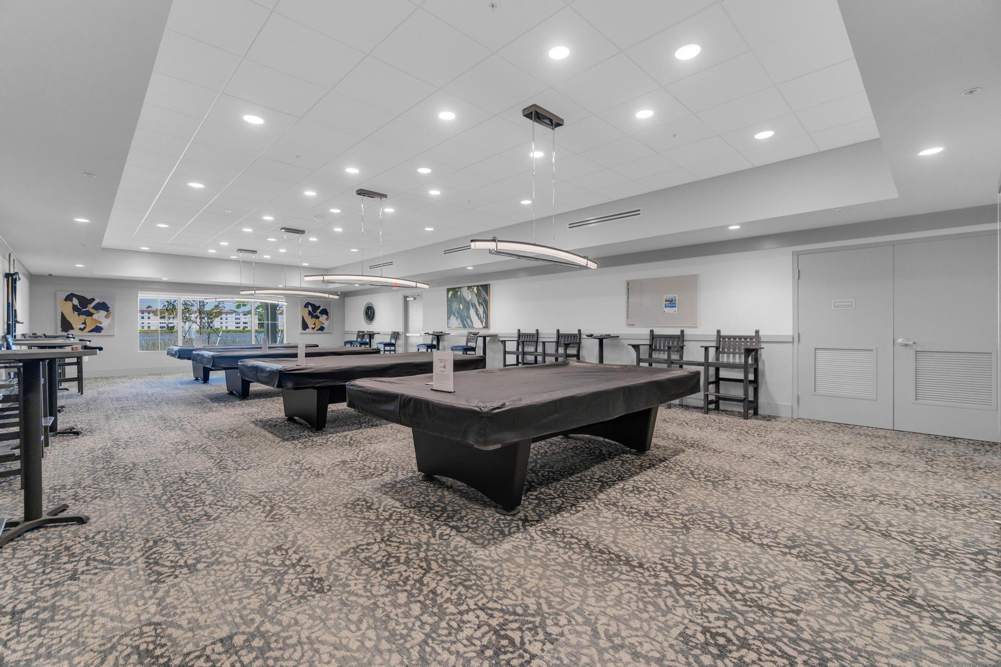 6241 Pointe Regal Circle, Unit 402 Delray Beach, FL 33484 - Photo 18 of 23 a living room with furniture and a table