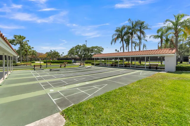 a view of a tennis ground with large trees