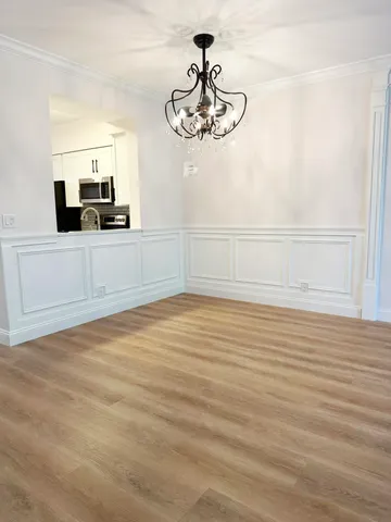a view of a room with rack and the view of kitchen