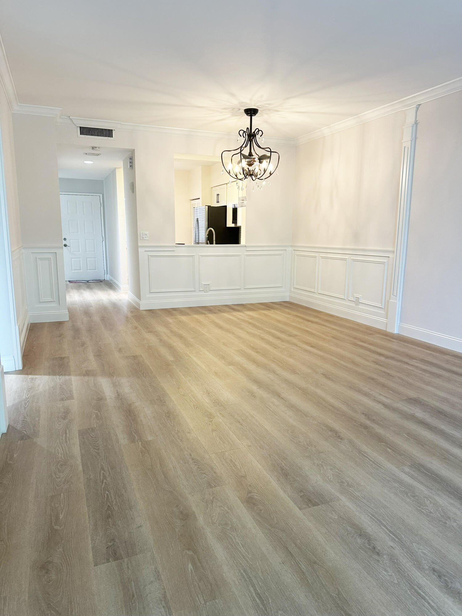 6241 Pointe Regal Circle, Unit 402 Delray Beach, FL 33484 - Photo 6 of 23 a view of a livingroom with a chandelier