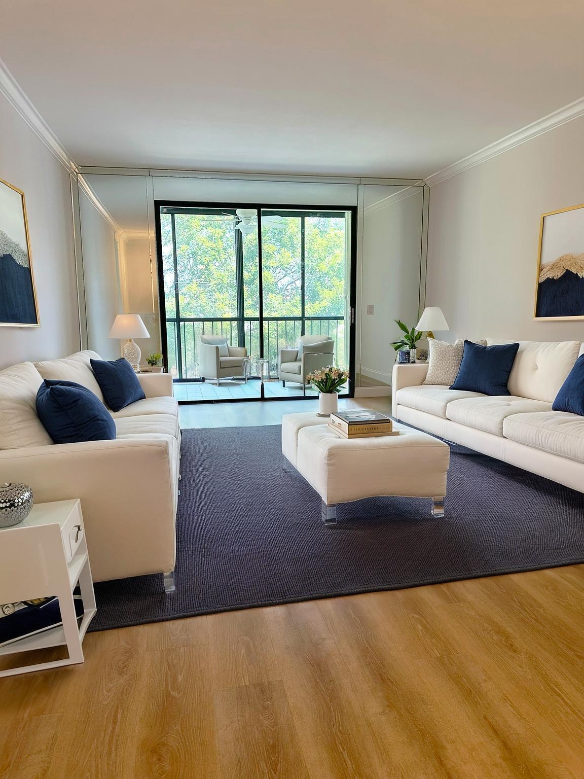 6241 Pointe Regal Circle, Unit 402 Delray Beach, FL 33484 - Photo 7 of 23 a living room with furniture and a large window