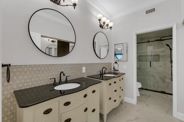 a bathroom with a granite countertop sink a large mirror and a shower
