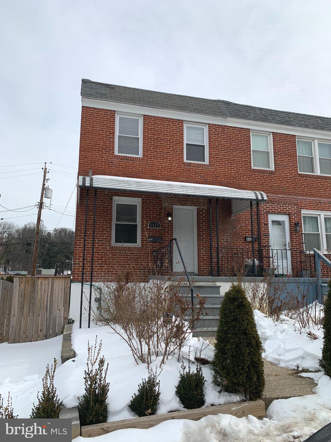4429 Newport Avenue Baltimore, MD 21211 - Photo 1 of 17 a front view of a house with a yard