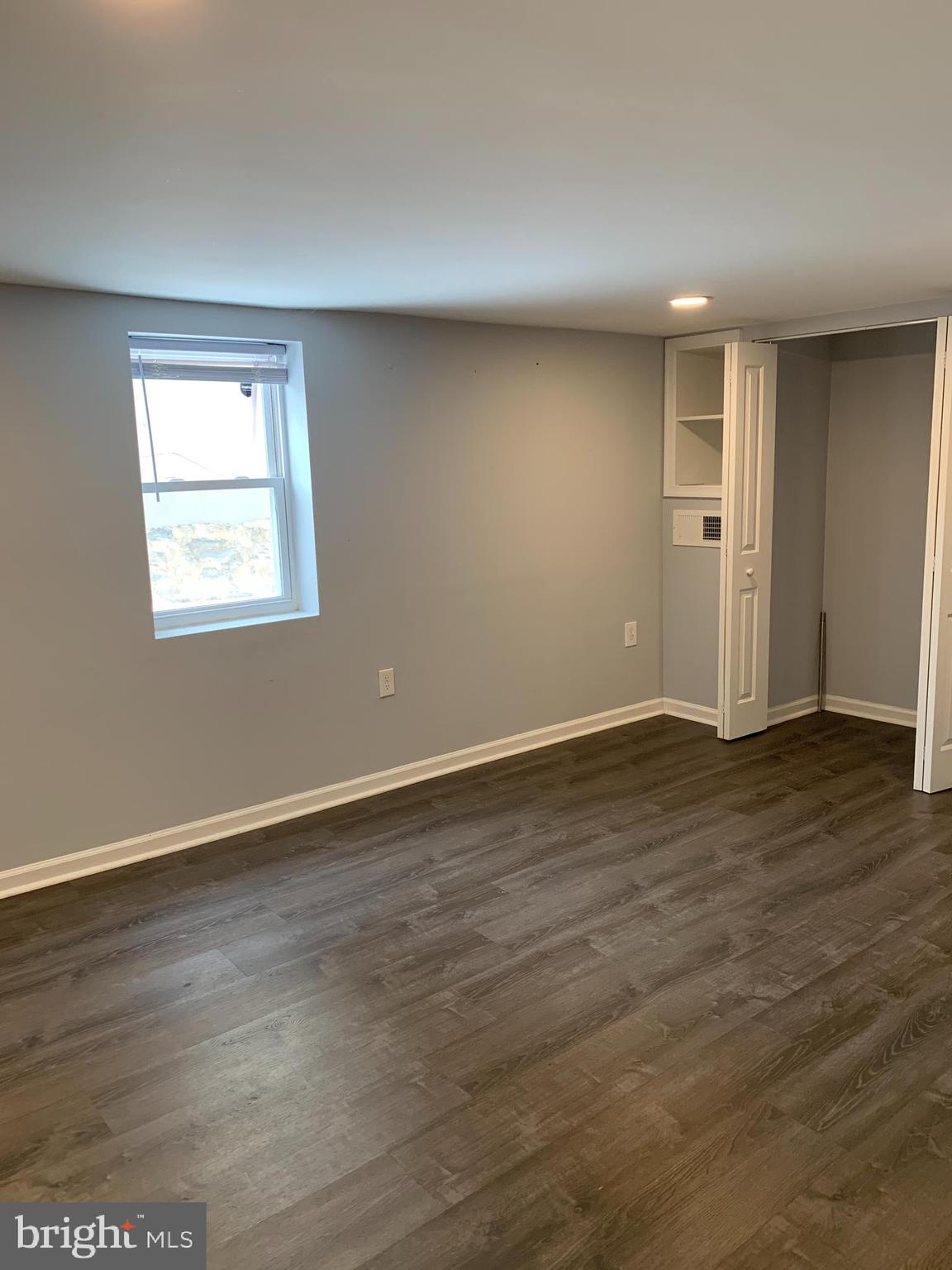 4429 Newport Avenue Baltimore, MD 21211 - Photo 11 of 17 an empty room with wooden floor and windows