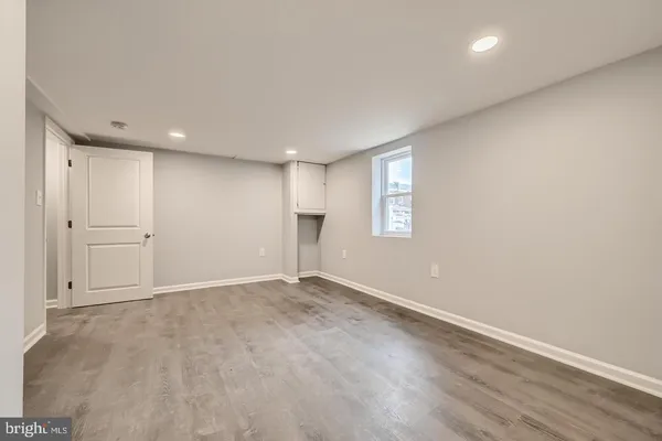 an empty room with windows and closet