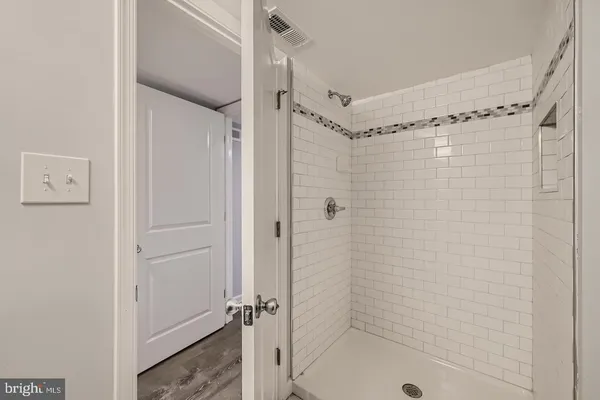 a bathroom with a shower and a glass door