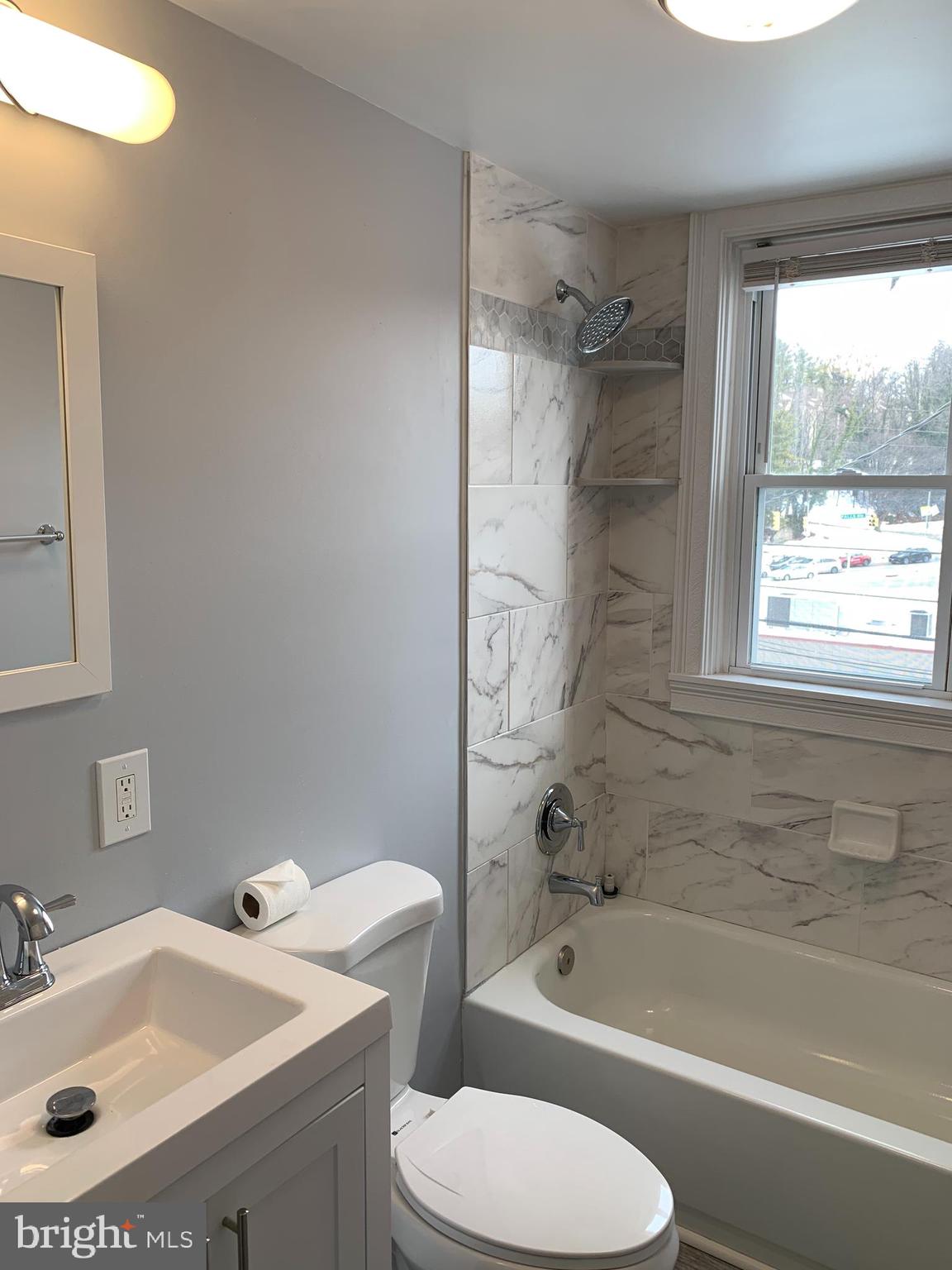 4429 Newport Avenue Baltimore, MD 21211 - Photo 6 of 17 a bathroom with a sink toilet and bathtub