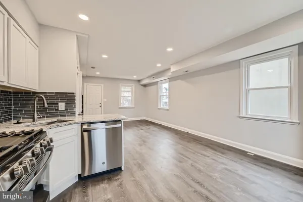 a kitchen with stainless steel appliances granite countertop a stove and a sink