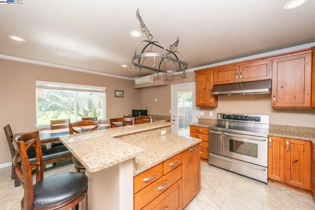 a kitchen with a stove a sink and a refrigerator