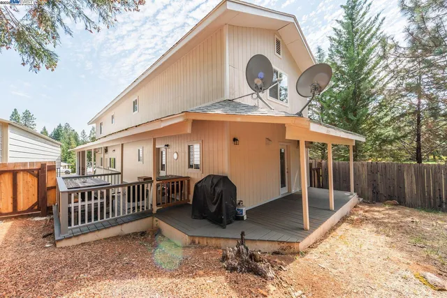 a view of a house with a yard and porch
