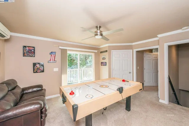 a living room with furniture and flat screen tv