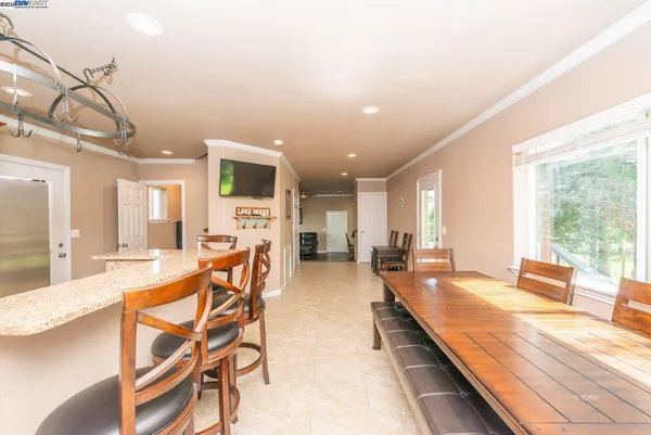 a large kitchen with a table and chairs in it