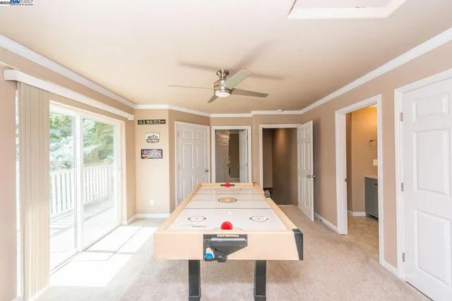 a white bed sitting in a bedroom next to a window
