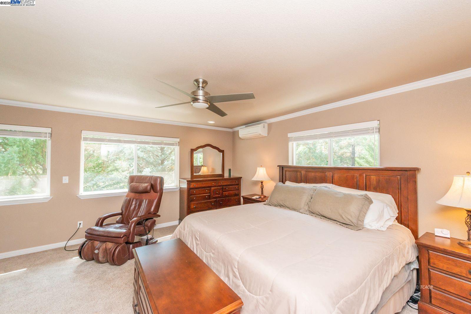 250 Mary Avenue Trinity Center, CA 96091 - Photo 26 of 49 a bedroom with a bed a chair and a chandelier