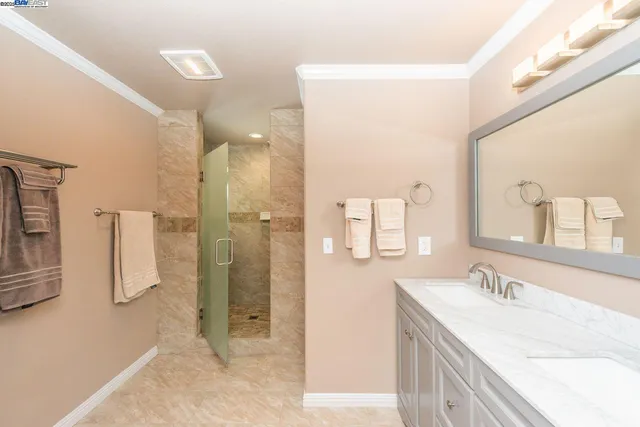 a bathroom with a granite countertop sink mirror and shower