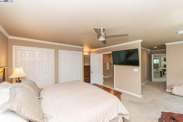 a bedroom with a large bed and a tv