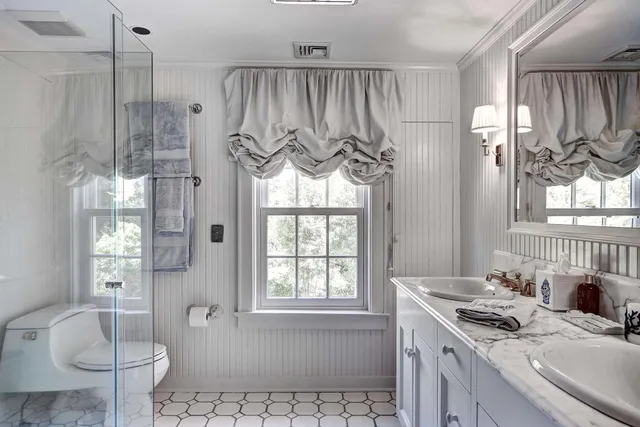 a bedroom with two beds and large window