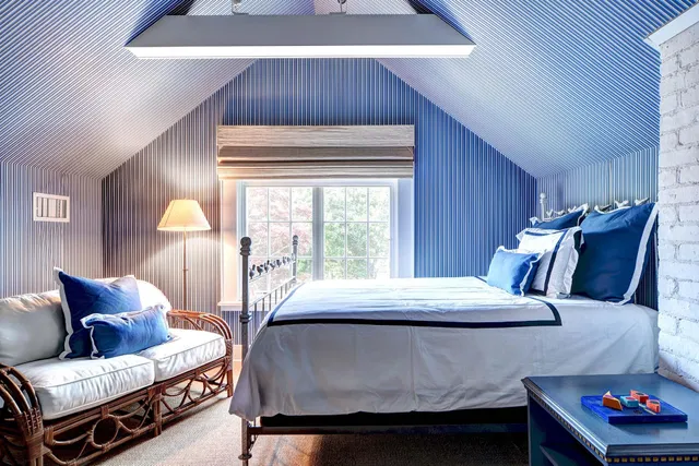 a living room with furniture and a dresser