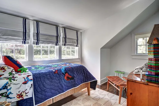 a bedroom with furniture and window