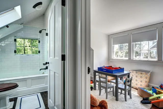 a bedroom with a bed and windows