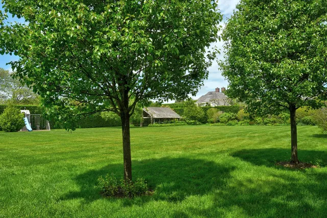 a view of a house with backyard and a sitting area