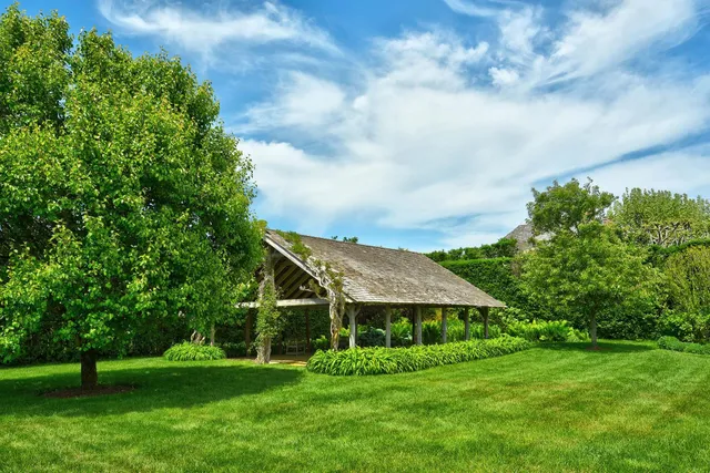 a view of a porch with furniture and garden